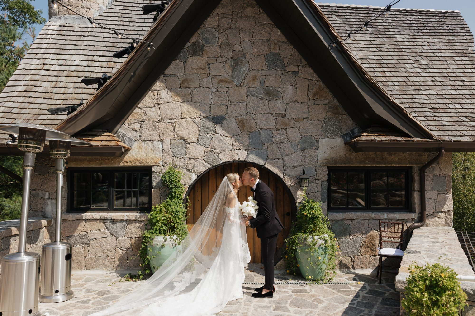 A couple share a first kiss at the stone cottage
