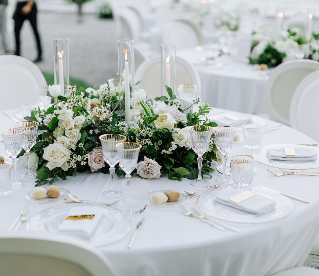 A reception table in white and greenery